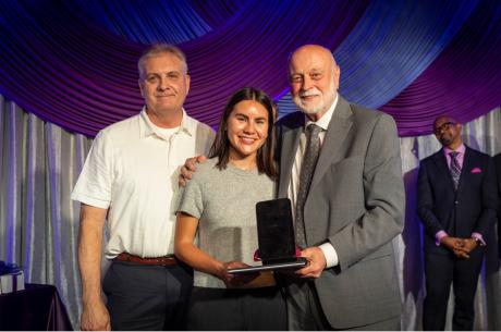 Dr. Richard Hart presents the Distinguished Service Award to Ben and Alexa Frazier in honor of Bing Frazier’s legacy of global service 
