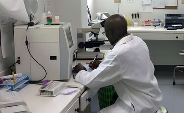 man in white coat doing research