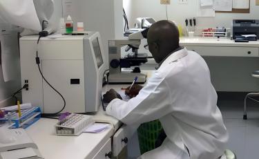 man in white coat doing research